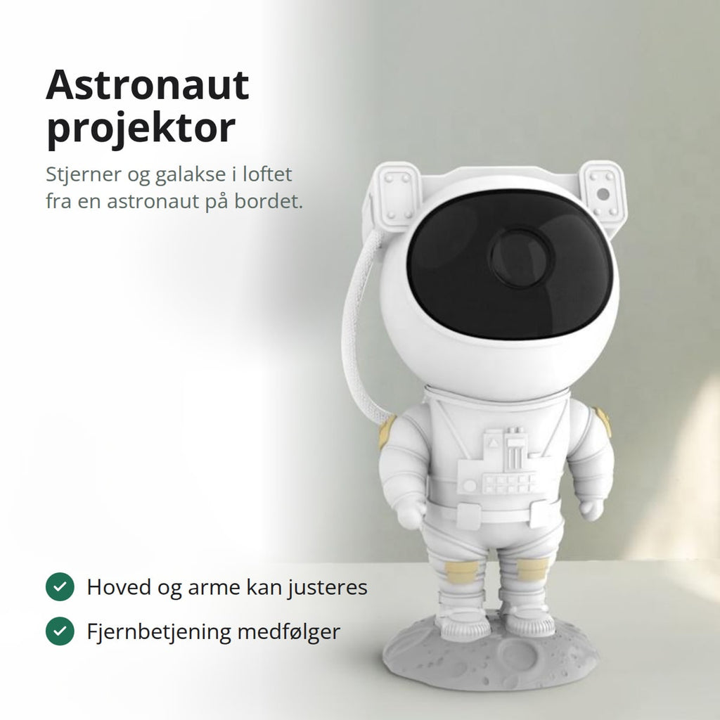 Hvid astronaut projektor på et bord ved et vindue med blomster i baggrunden
