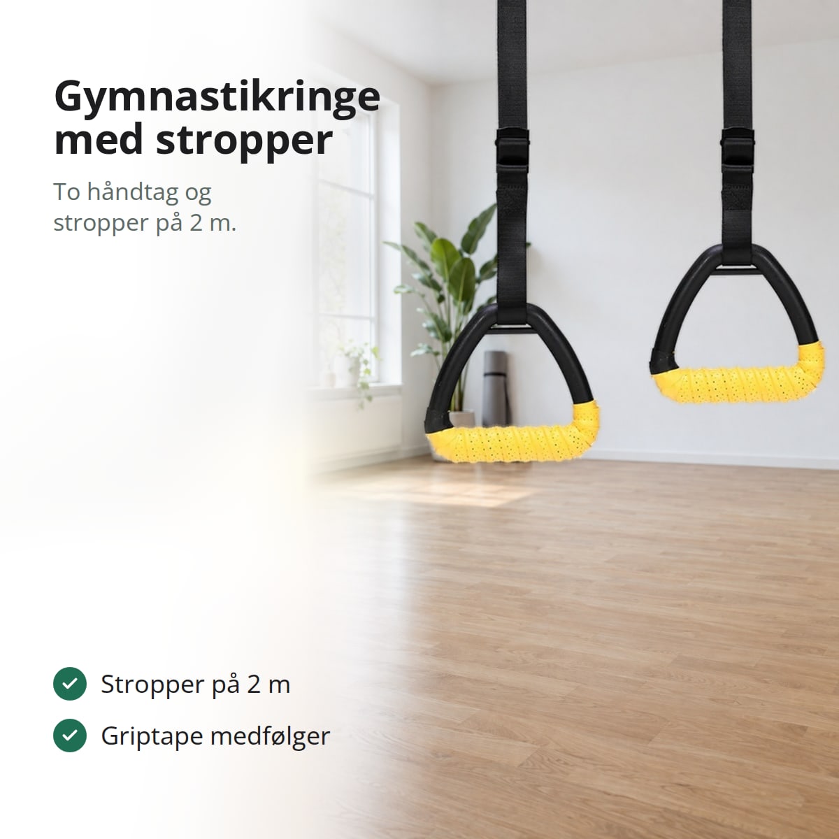 Gymnastikringe med trekantede håndtag og gul griptape, der hænger i sorte stropper i et lyst rum