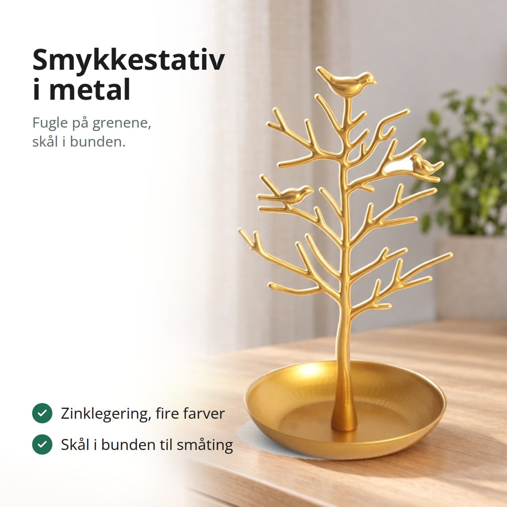 Smykkestativ i metal med fugle på grenene og skål i bunden, med tekst: zinklegering i fire farver
