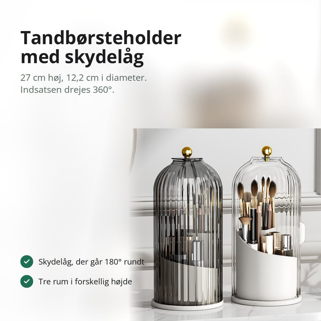 Tandbørsteholder i klar plast med riflet overflade og skydelåg, stående på en bordplade på badeværelset