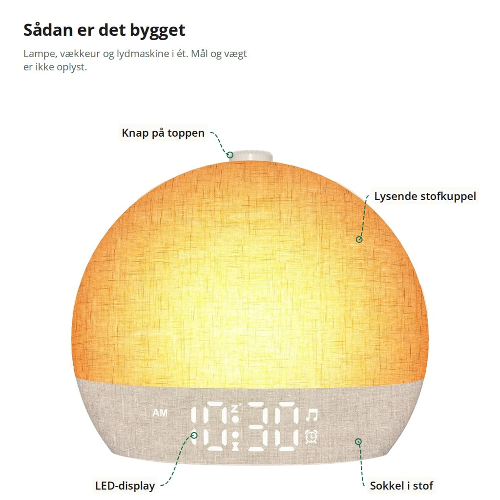 Vækkeuret med markeringer: knap på toppen, lysende stofkuppel, LED-display og sokkel i stof; lampe, vækkeur og lydmaskine i ét, mål og vægt er ikke oplyst